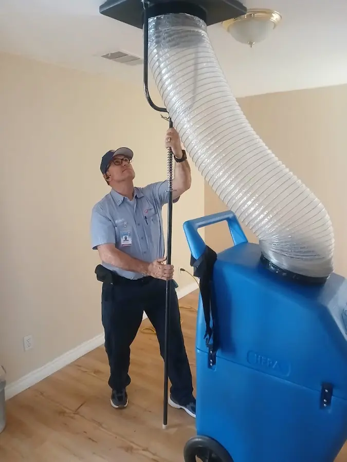 Furnace Tune-Up technician using HEPA equipment in Cedar Rapids